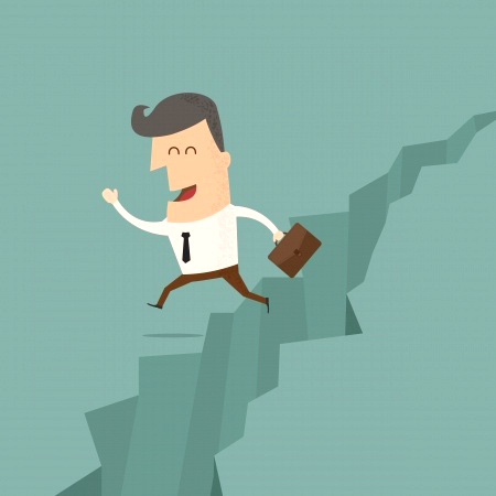 Businessman leaping a chasm